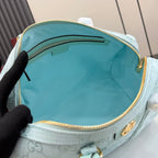 Mint GG-pattern handbag interior view with fabric lining and gold zipper trim.