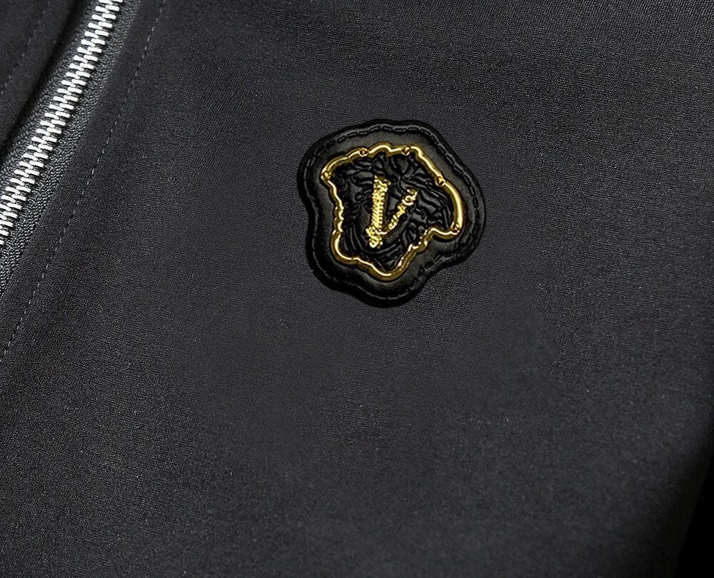Black track jacket emblem patch on chest
