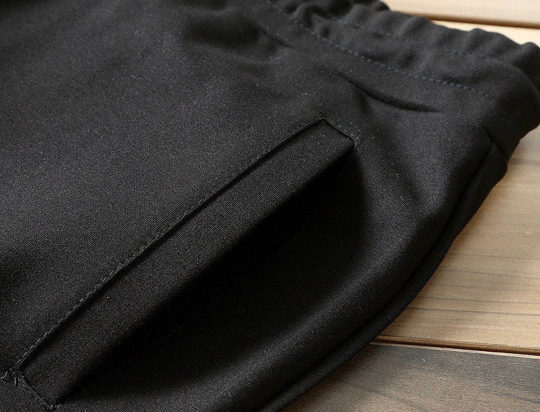 Black jogger pants with stitched seam and textured fabric