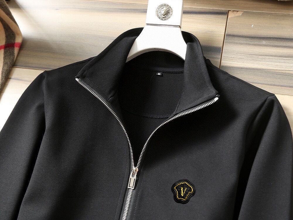 Black zip-up track jacket with metal zipper and small chest emblem