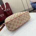 Gucci hobo bag side profile with GG print canvas and brown leather trim