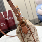 Gucci bag strap and buckle detail with brown leather and GG canvas body