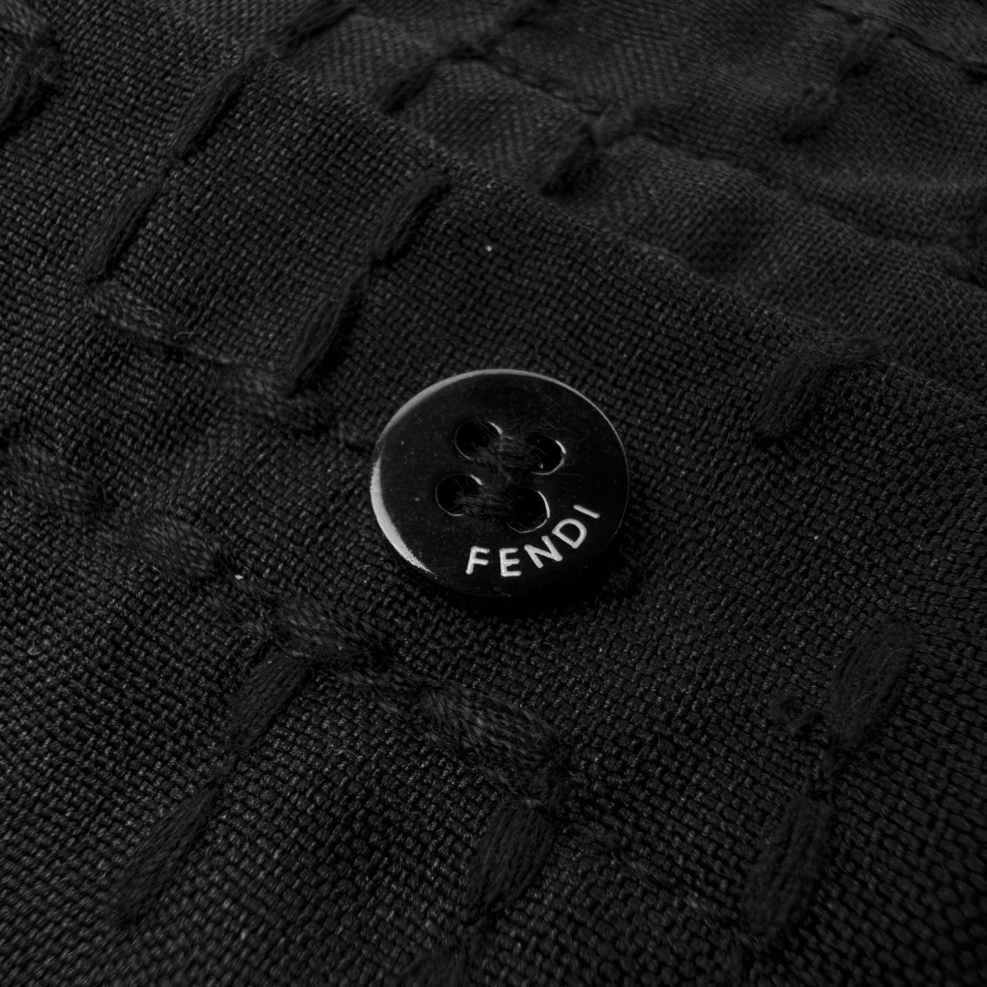 Fendi shirt button detail on dark black jacquard fabric with FENDI emboss