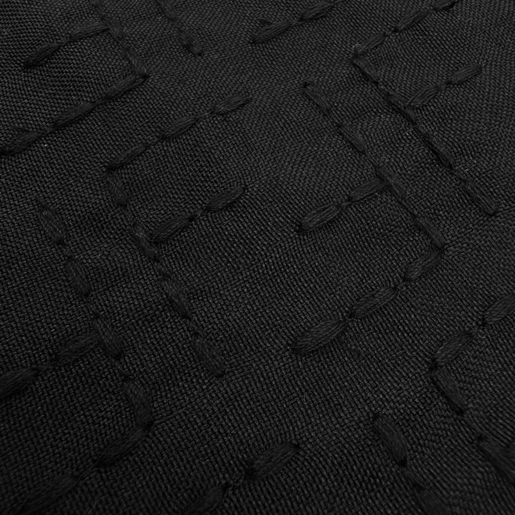 Fendi shirt fabric close-up, dark black jacquard weave with logo-like pattern