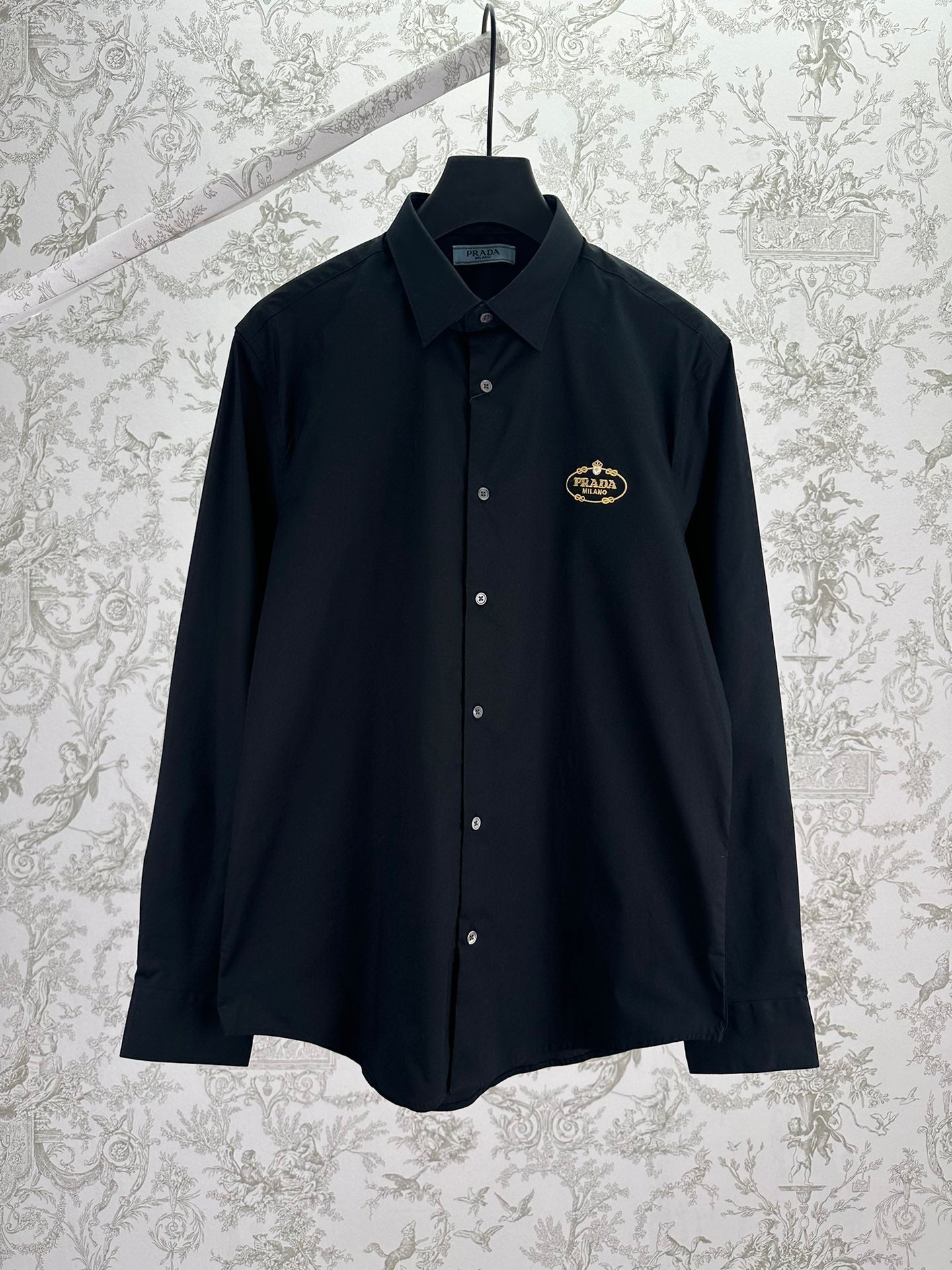 Black Prada long-sleeve button-up shirt with gold crest logo on chest