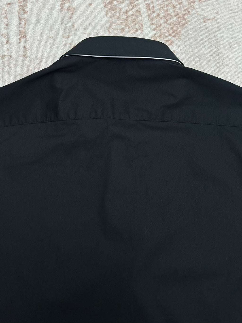 Black long-sleeve shirt back with collar yoke seam and smooth fabric