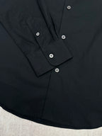 Long-sleeve button-up shirt front placket with dark buttons and collar