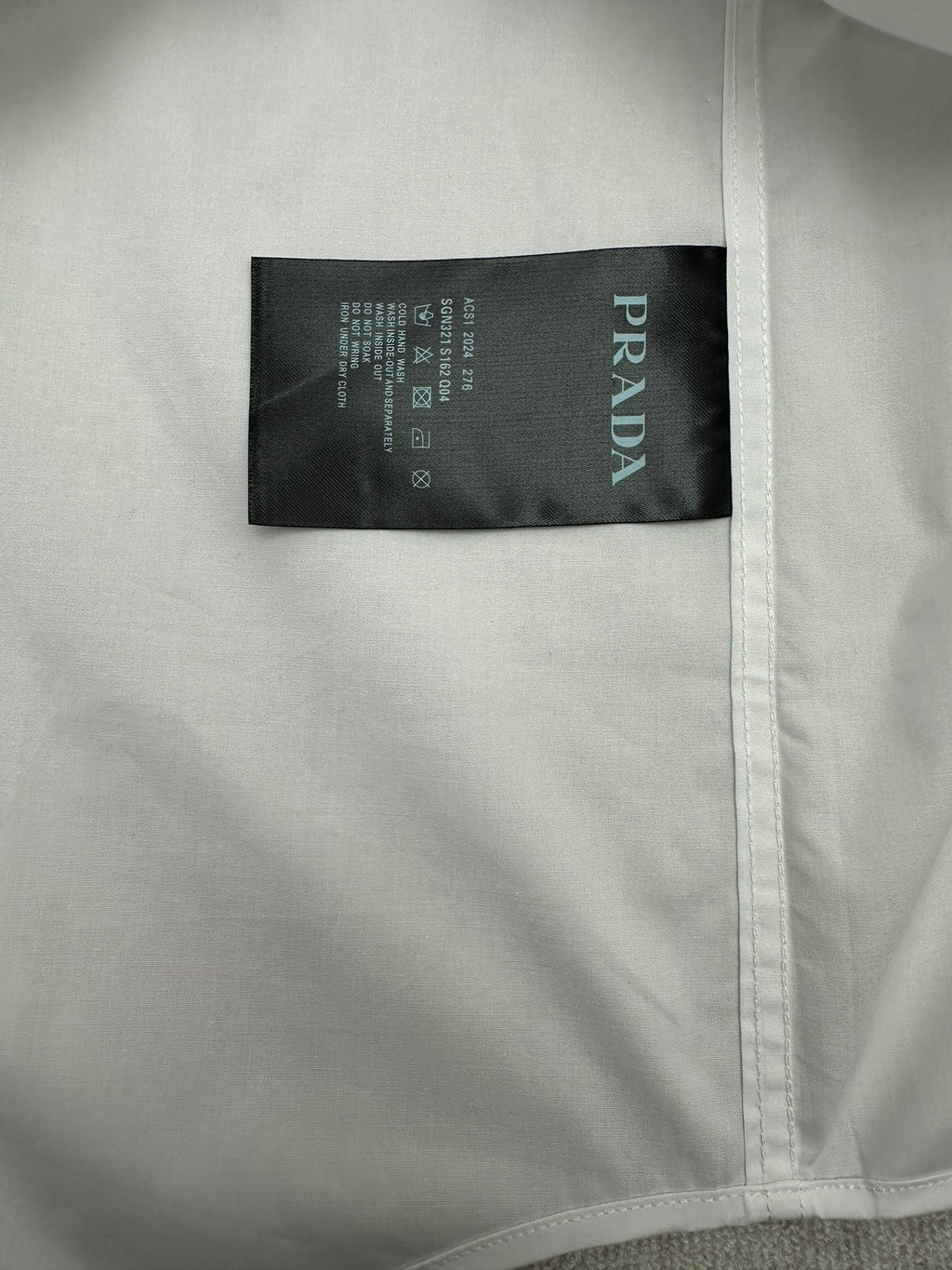 White shirt with black Prada size and care label inside