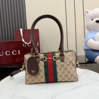 Gucci canvas handbag with brown leather handles, gold hardware, and green-red stripe panel