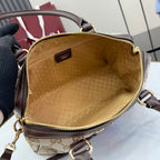 Gucci handbag interior view with brown lining, gold zipper edge, and leather top rim