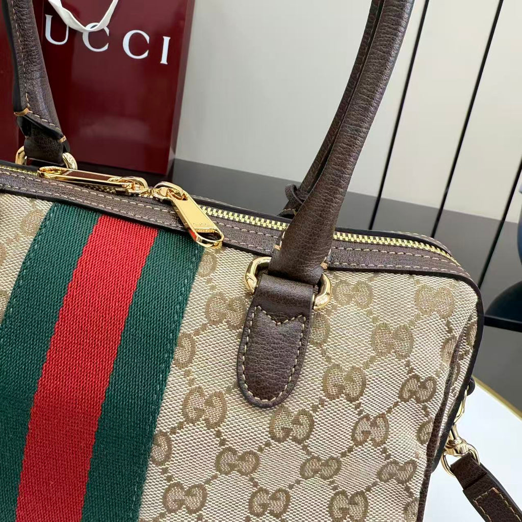 Striped GG canvas handbag with brown leather strap, zip-top and gold-tone hardware
