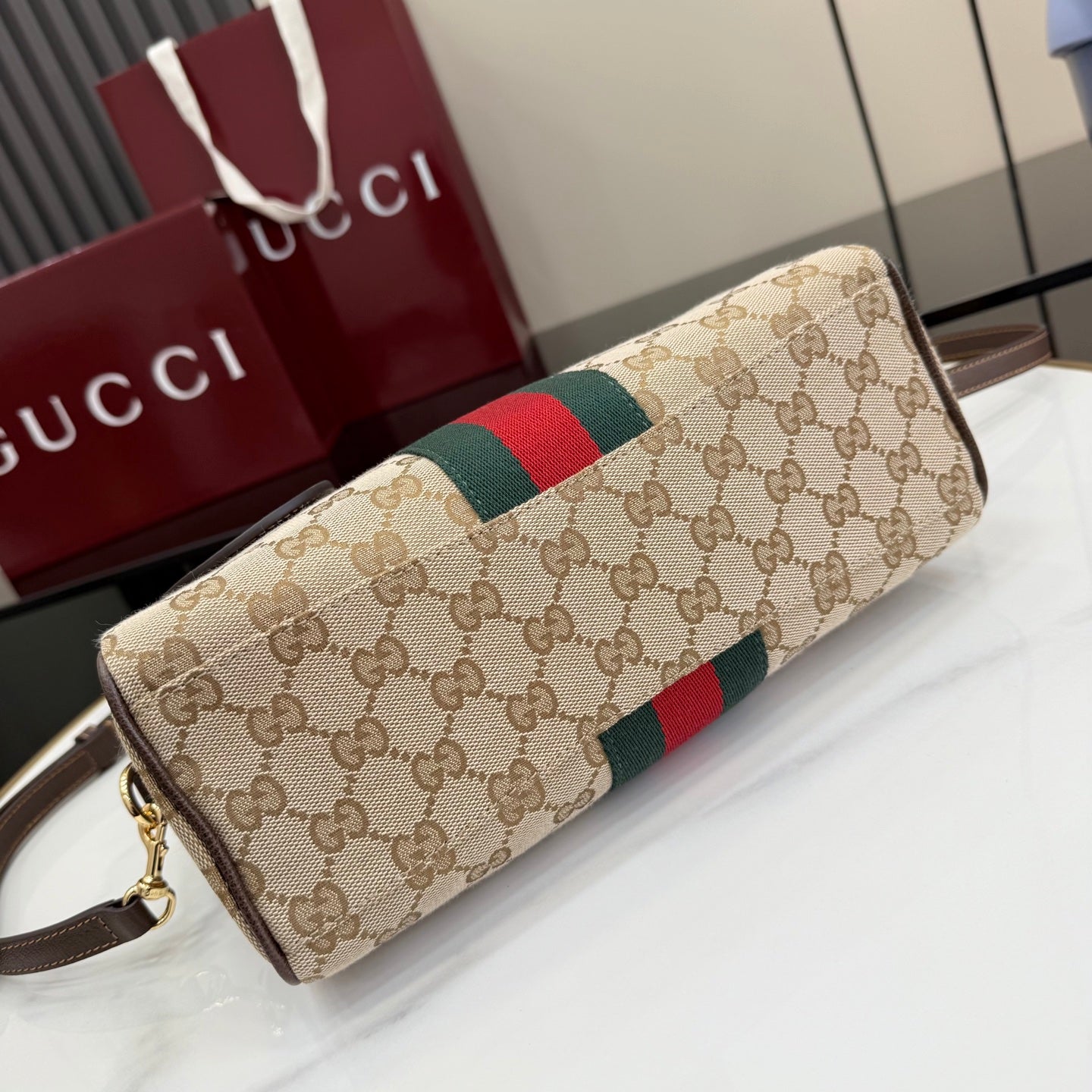 Gucci canvas long handbag with green-red web stripe, brown trim, and gold zipper detail