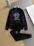 Black sweatshirt and jogger set with Versace Medusa logo, on hangers