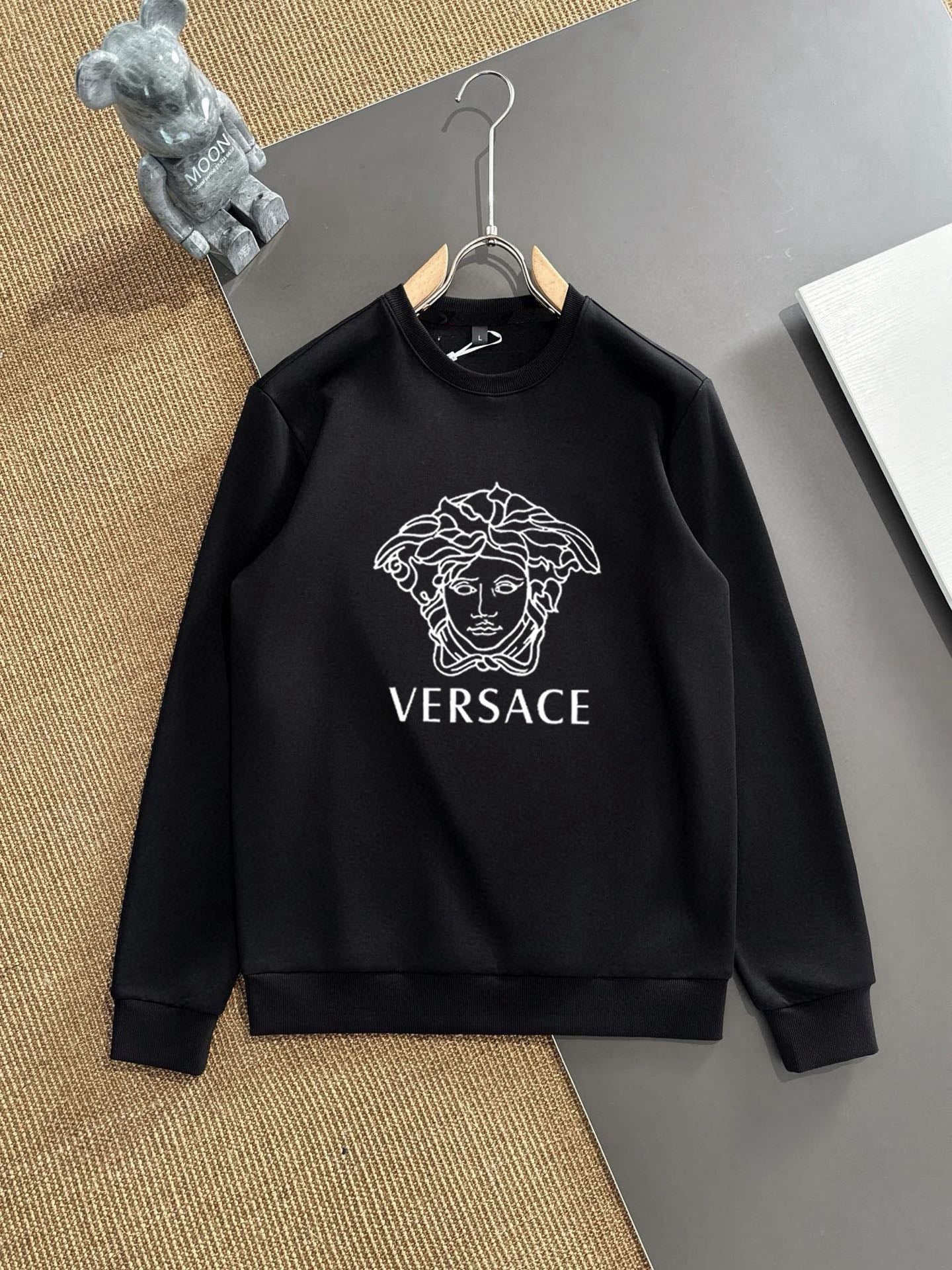 Black crewneck sweatshirt with large Versace Medusa logo print