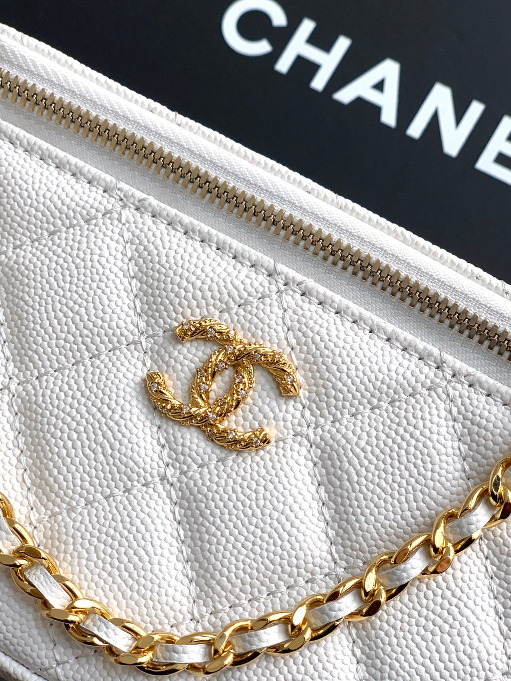 Quilted white bag front with gold CC logo and gold chain detail