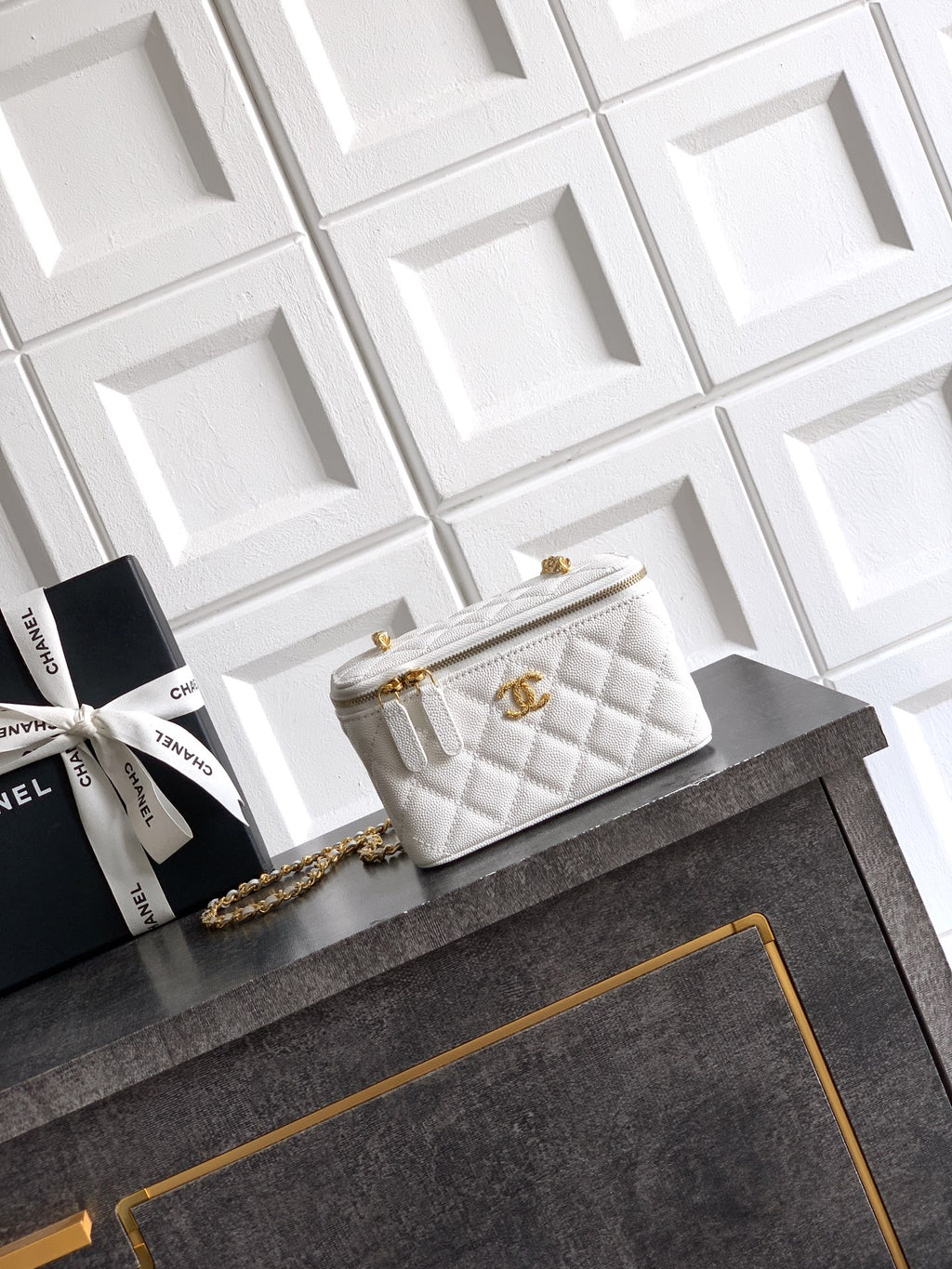 Quilted white leather bag with gold chain strap and front flap closure
