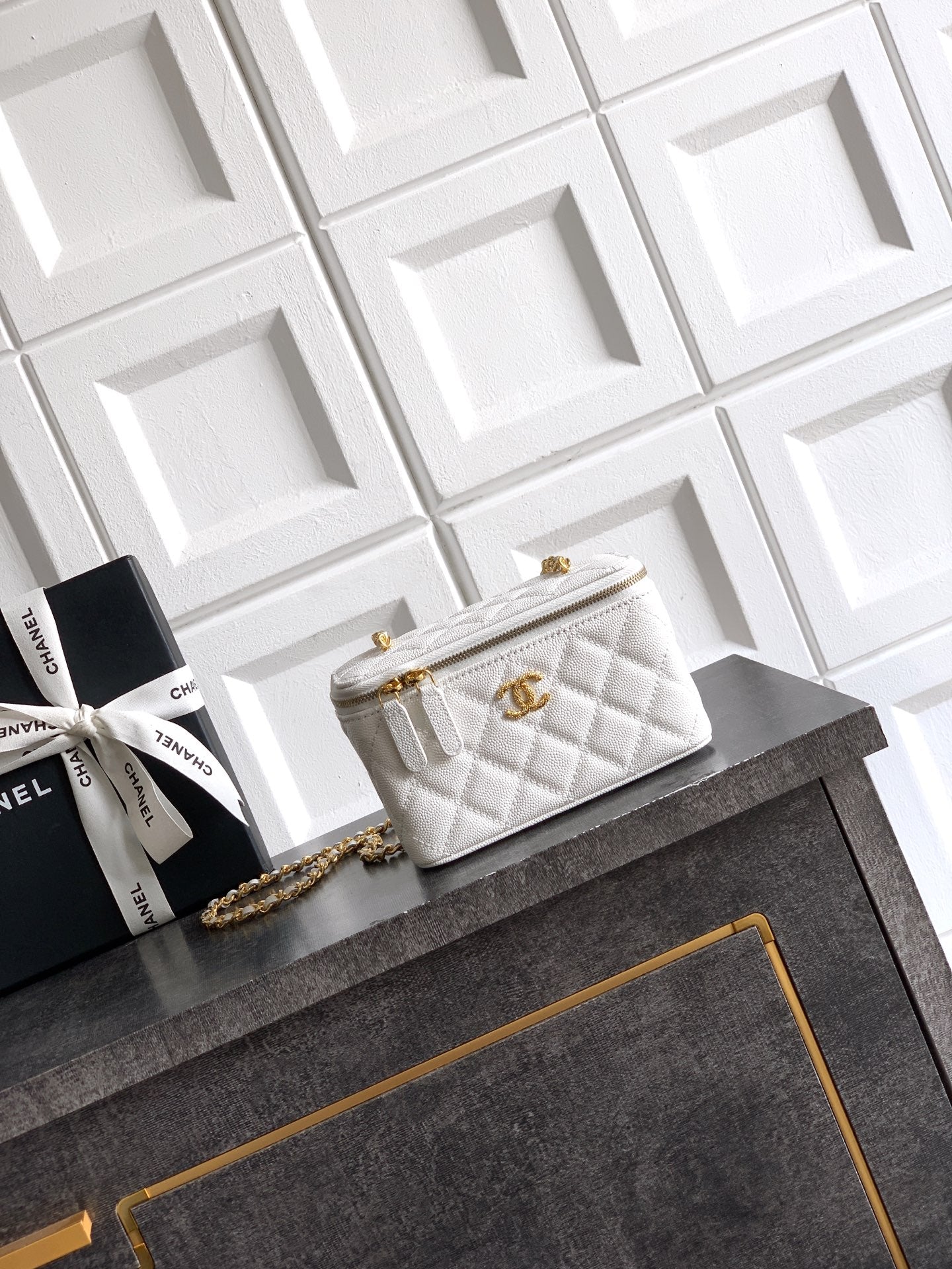 Quilted white leather bag with gold chain strap and front flap closure