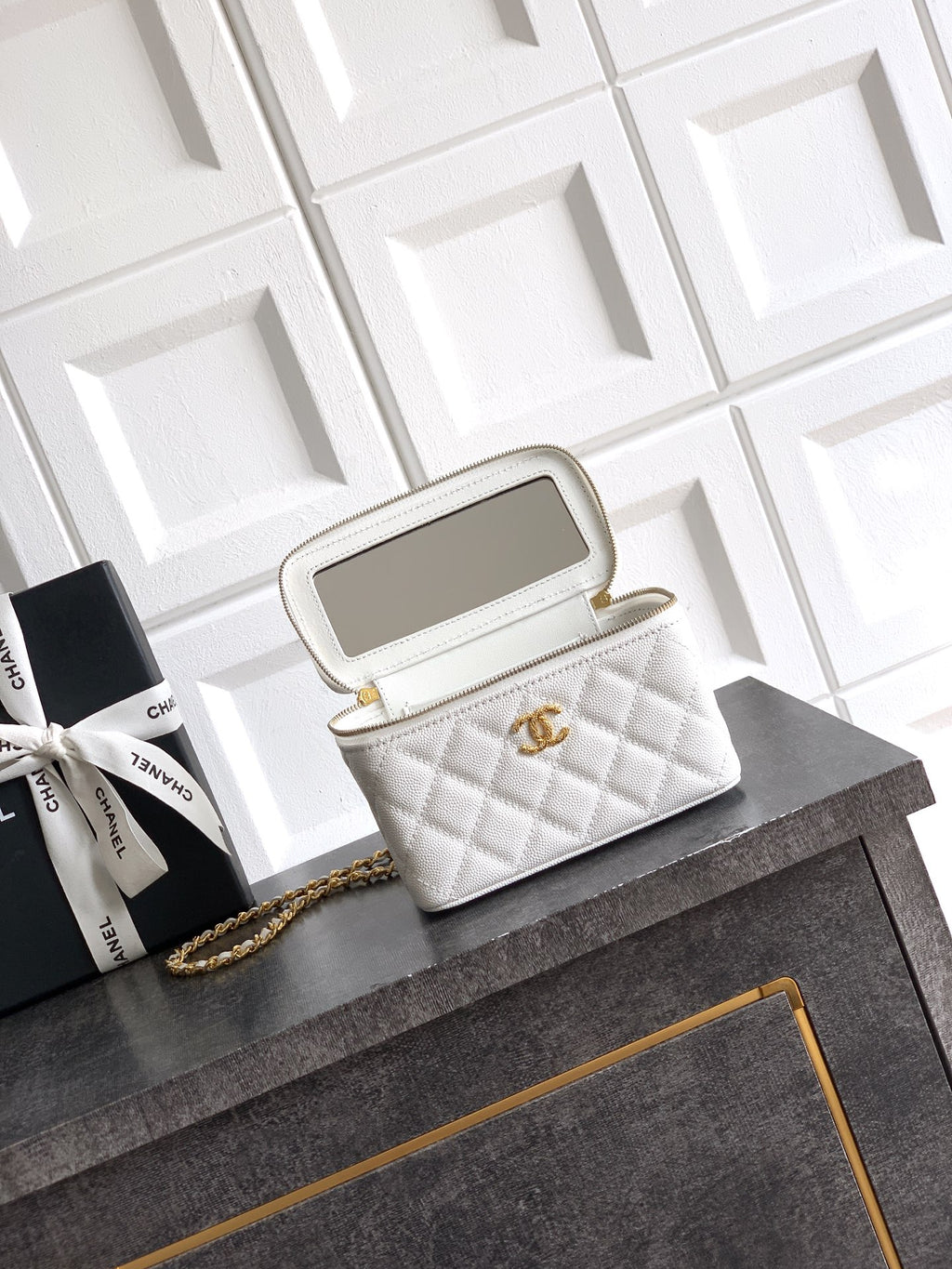 Quilted white leather top-handle bag with gold chain strap and open top view