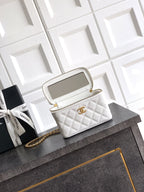 Quilted white leather top-handle bag with gold chain strap and open top view