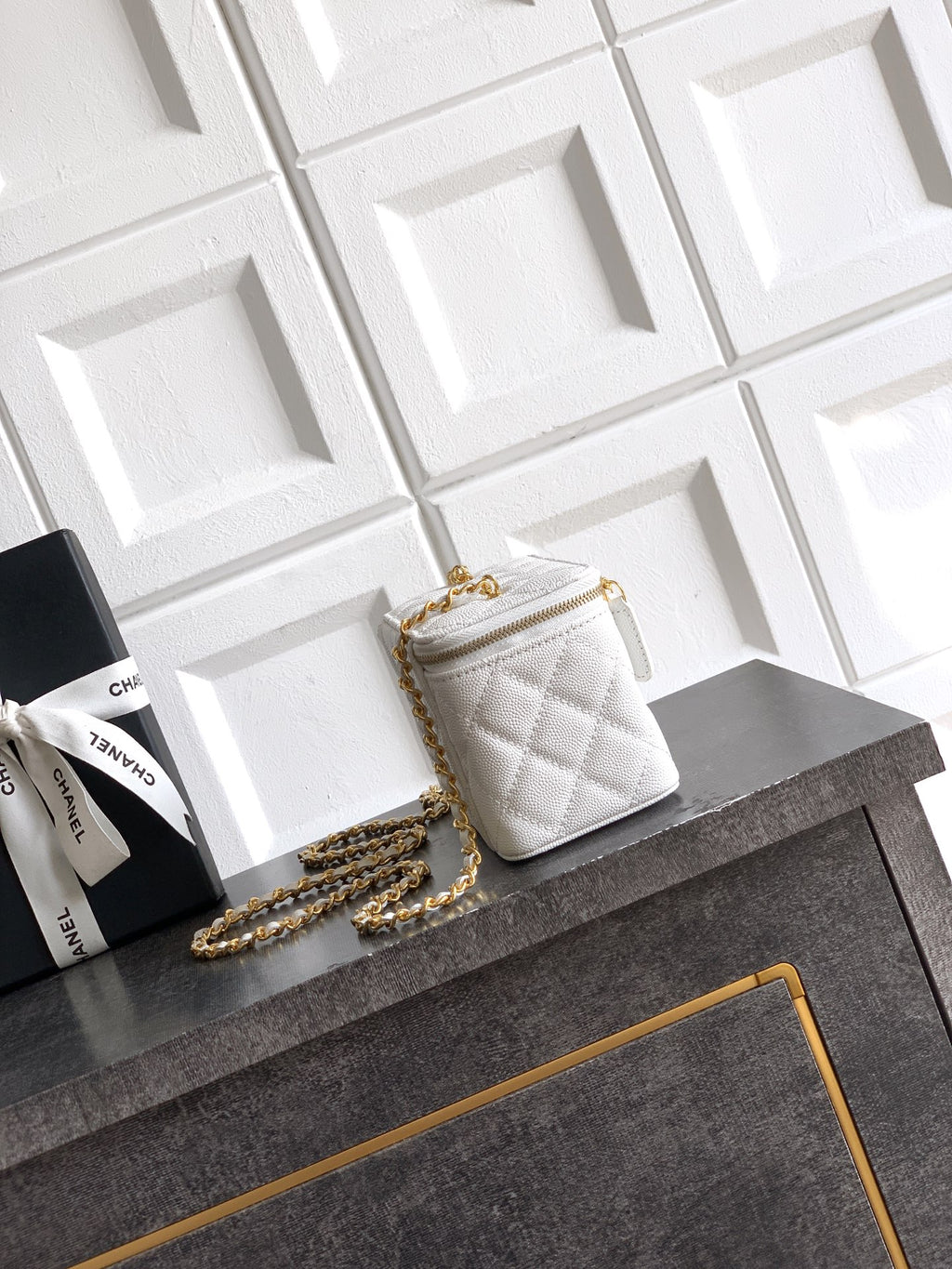 Quilted white leather crossbody bag with gold chain strap and small top handle