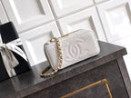 Quilted white leather shoulder bag with gold chain strap and snap-front flap