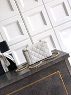 Quilted white leather bag with gold chain shoulder strap and front flap