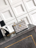 Light gray quilted Chanel bag with gold-tone chain strap and zip closure.