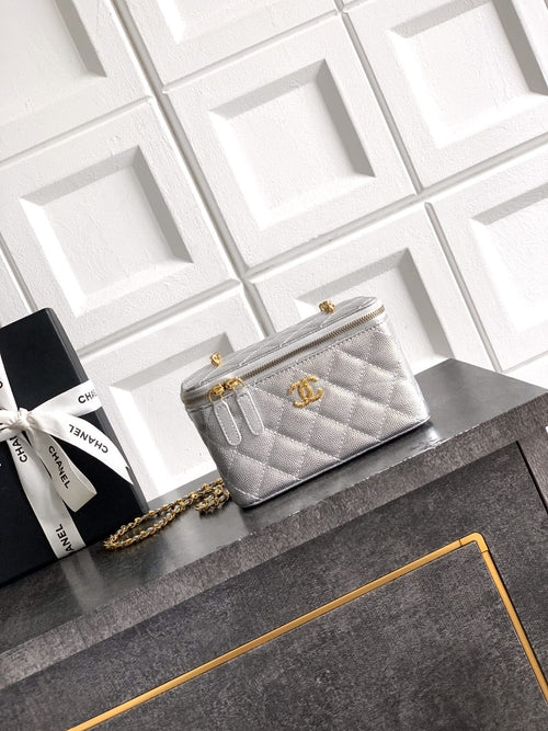 Light gray quilted Chanel bag with gold-tone chain strap and zip closure.