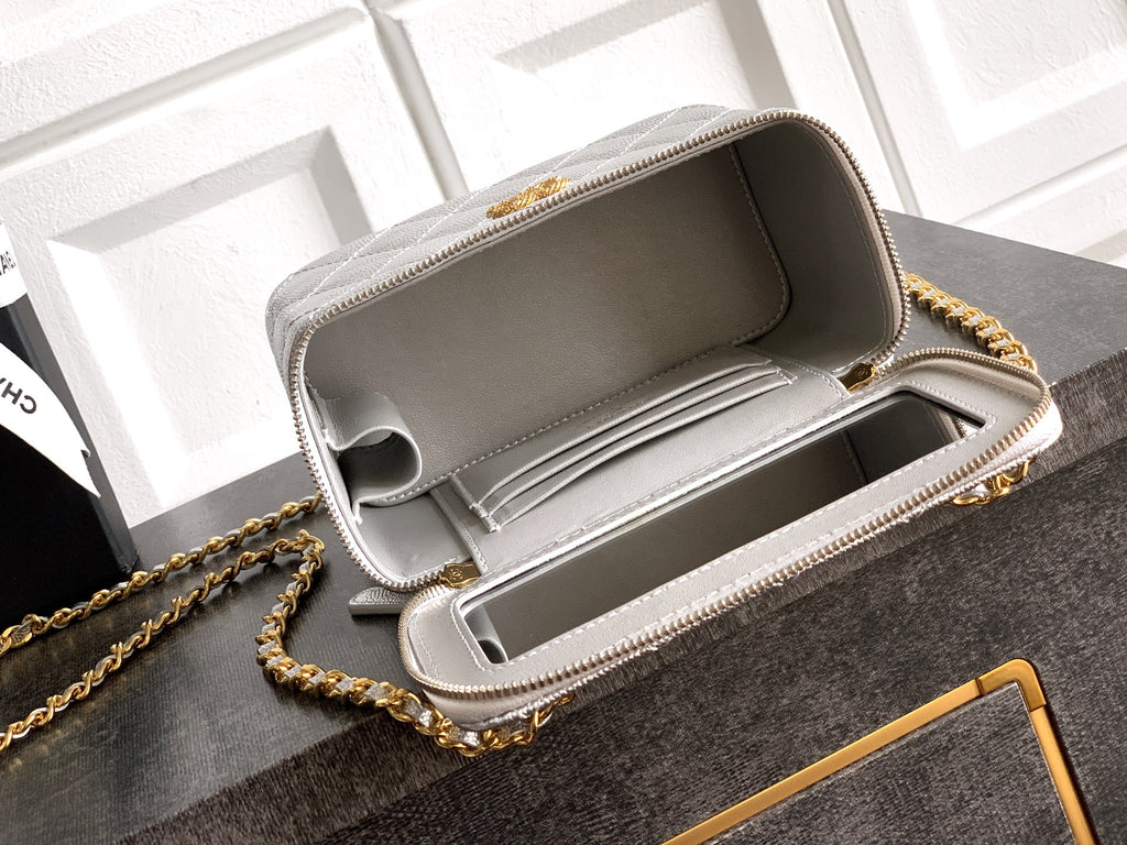 Light gray Chanel bag open top showing structured interior and zip lining.