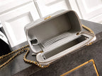 Light gray Chanel bag open top showing structured interior and zip lining.