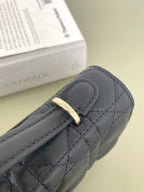 Dior quilted leather bag corner with gold-tone buckle and stitched strap, dark navy