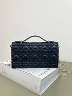 Dior quilted leather handbag with top handle, bow detail, and flap closure, dark navy