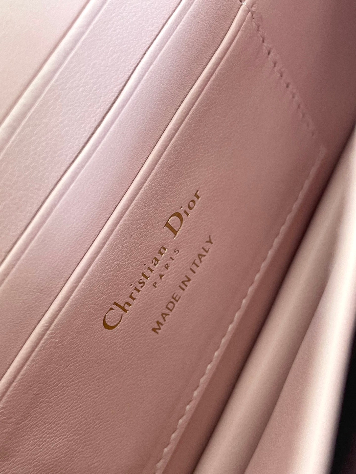 Pink leather bag interior with Dior logo and Made in Italy stamp