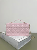 Pink quilted Dior handbag with geometric diamond pattern and gold chain strap