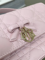 Pink quilted leather flap bag with knotted bow logo clasp