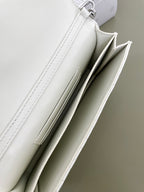 White quilted bag interior opening showing two compartments and stitching