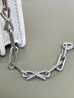 White quilted bag with silver chain strap and clasp hardware