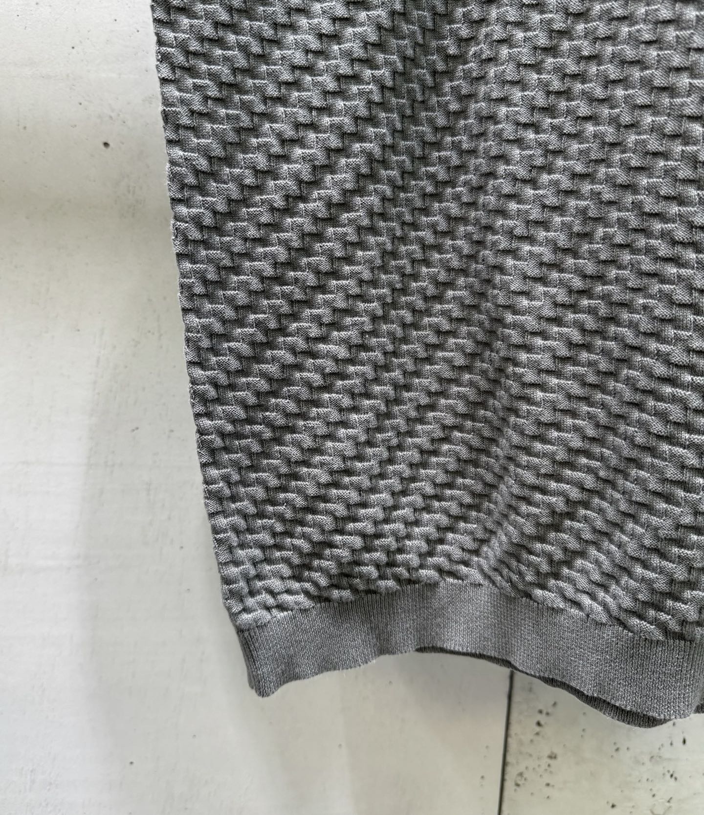 Amiri knit sweater hem and cuff in heather gray with ribbed trim.