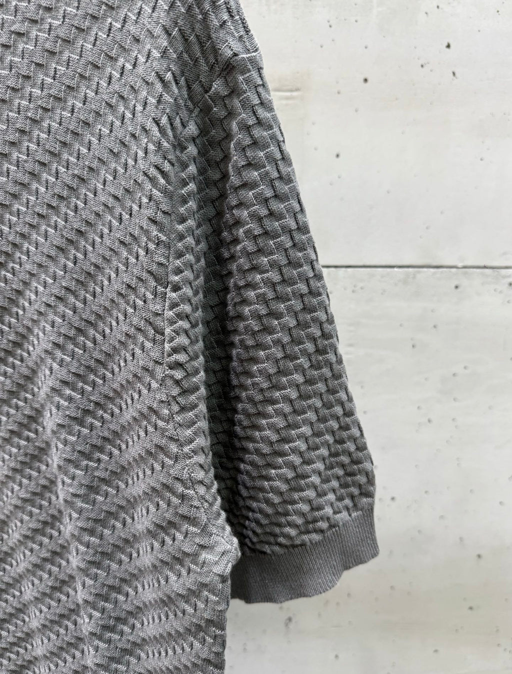 Amiri knit sweater side view in heather gray, textured herringbone knit.