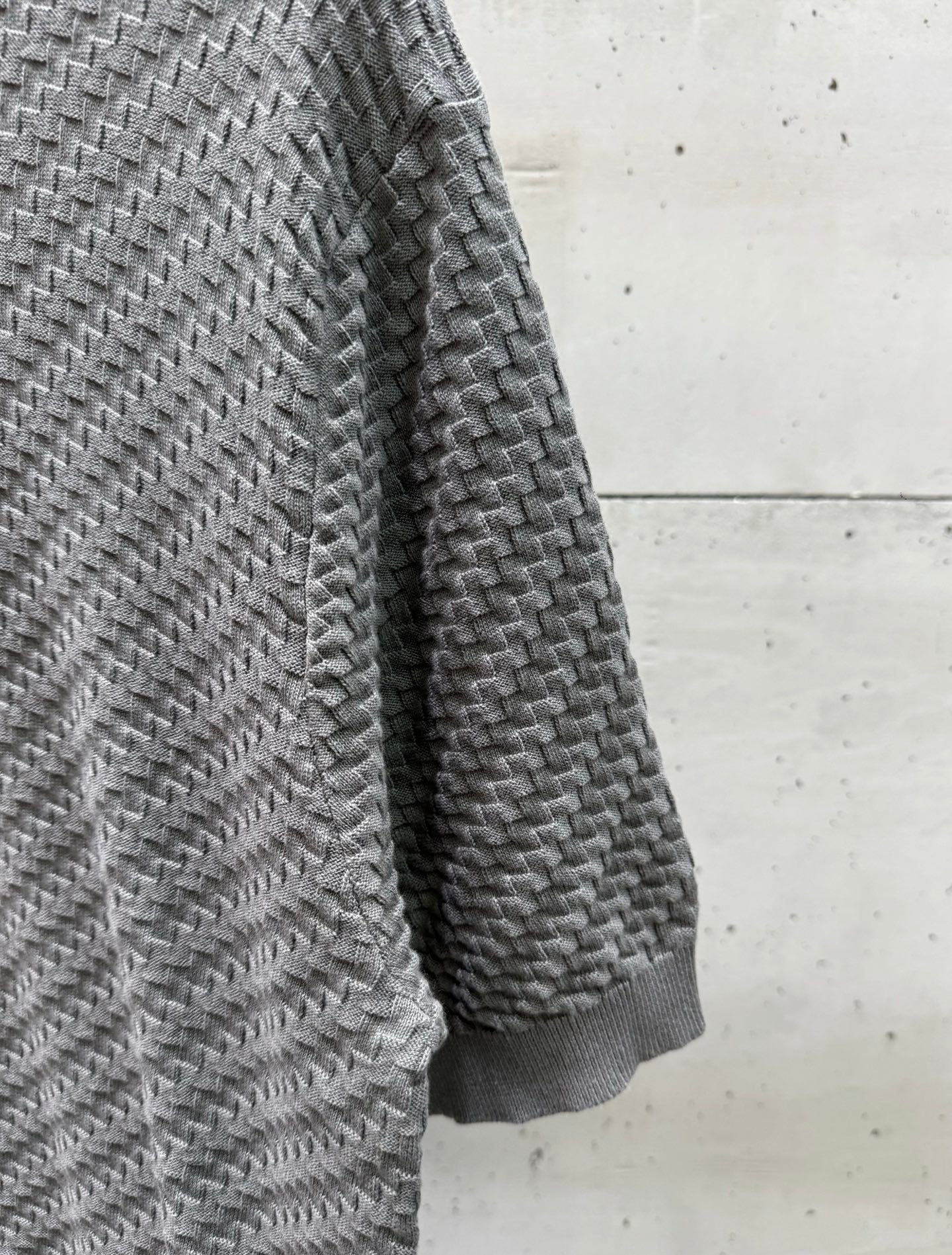 Amiri knit sweater side view in heather gray, textured herringbone knit.