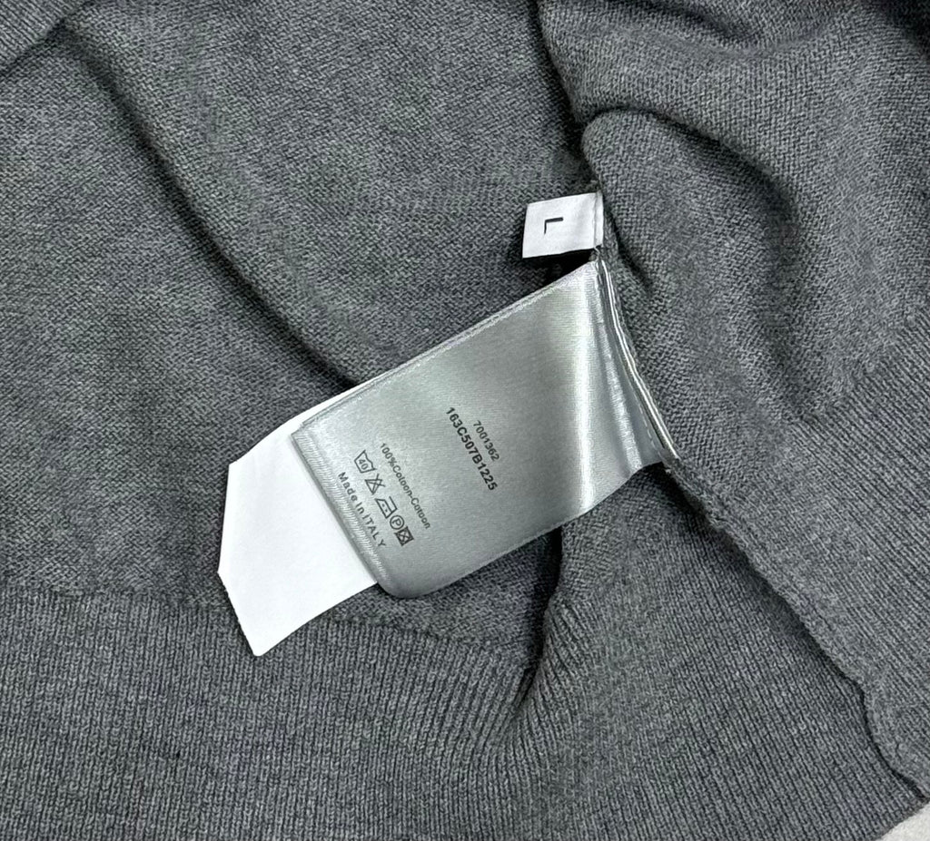 Prada polo shirt care label close-up on heather gray knit near the collar