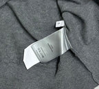 Prada polo shirt care label close-up on heather gray knit near the collar
