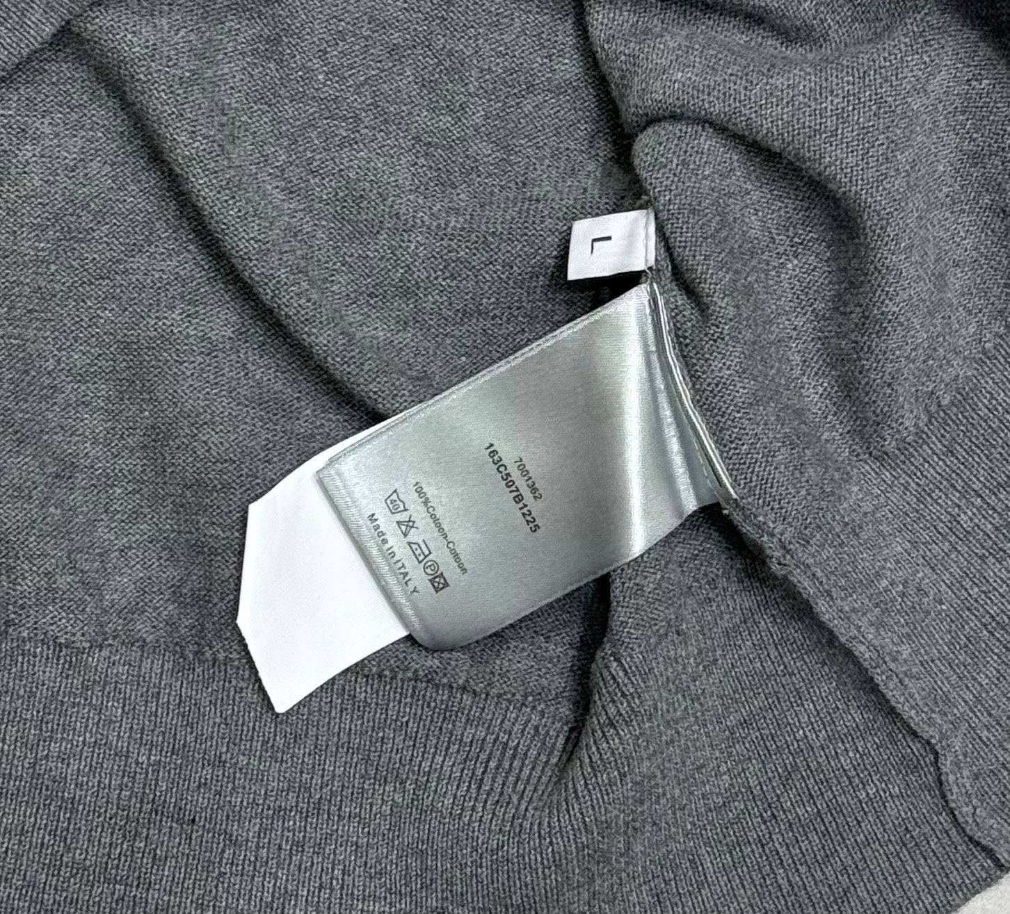 Prada polo shirt care label close-up on heather gray knit near the collar