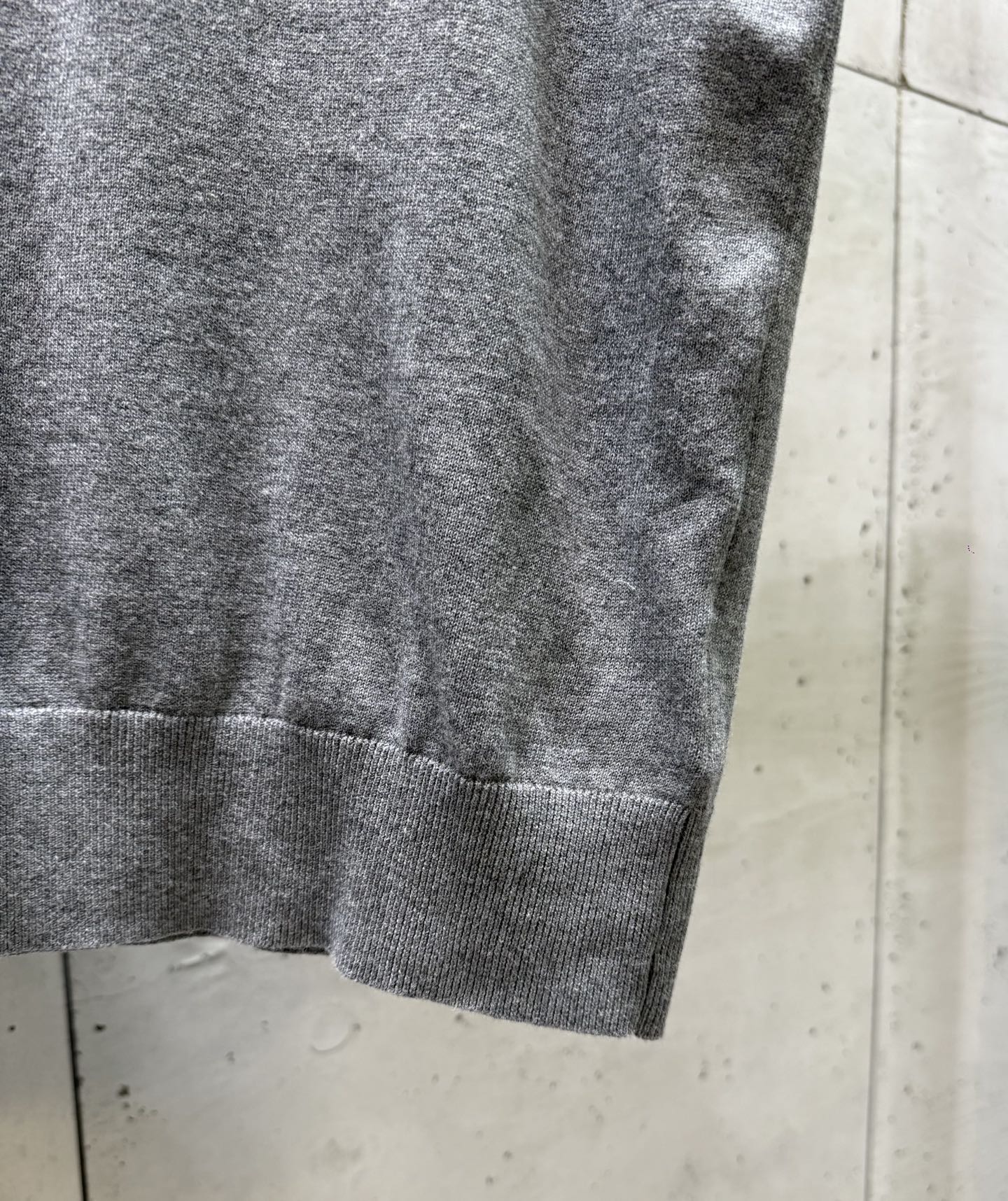 Prada polo shirt sleeve and hem detail, heather gray knit with ribbed bottom cuff