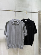 Gray and black short-sleeve polo shirts on hangers