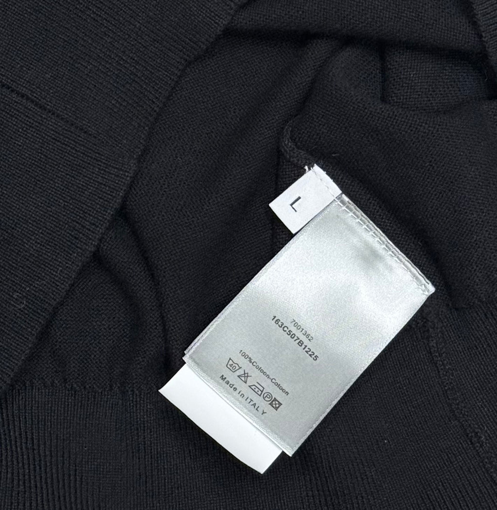 Black polo shirt fabric with size label marked L