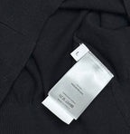 Black polo shirt fabric with size label marked L