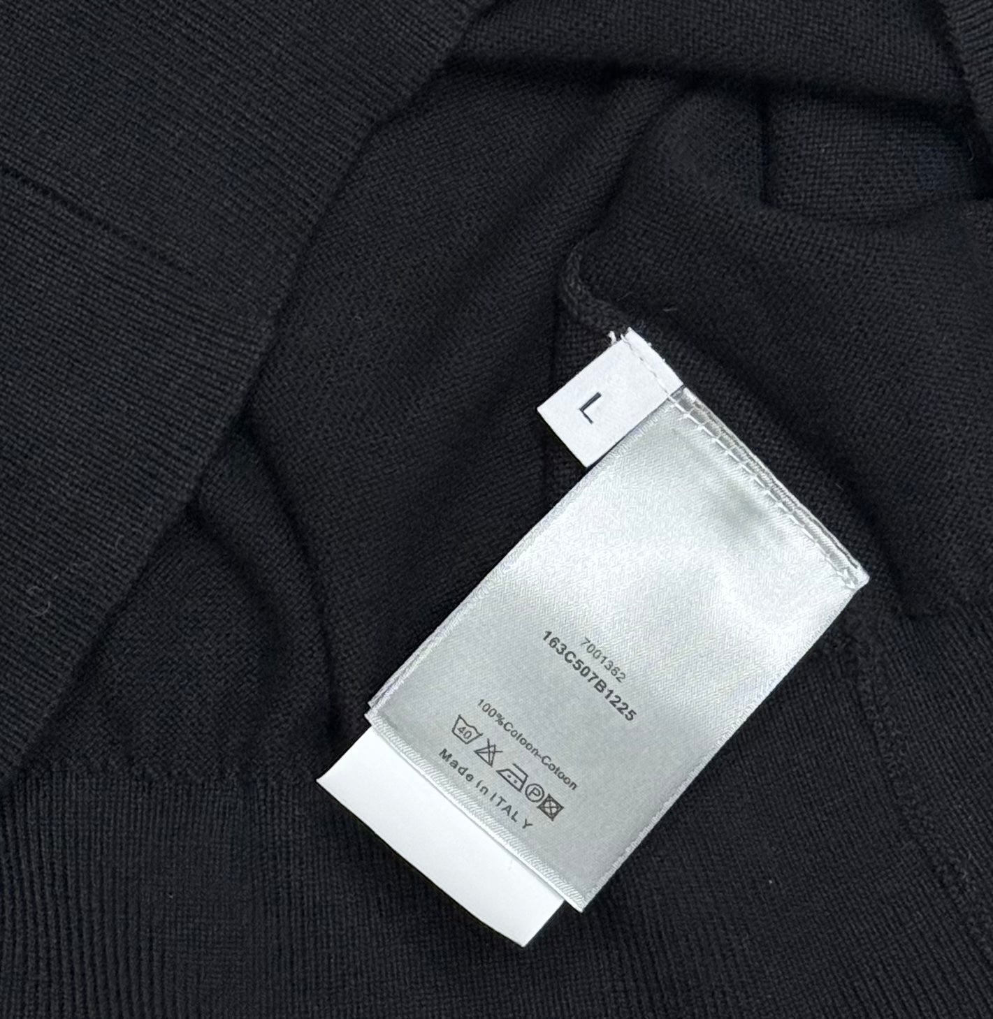 Black polo shirt fabric with size label marked L