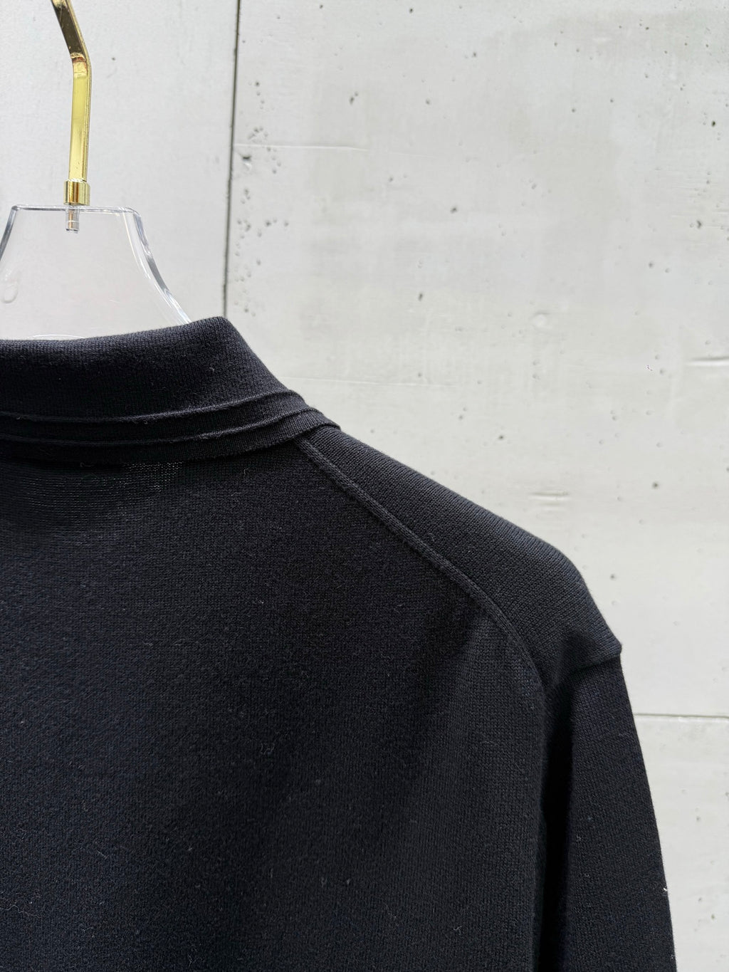 Black polo shirt shoulder seam and high ribbed collar