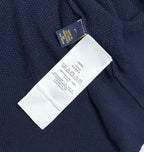 Navy polo sweater care label and size tag close-up